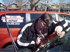 worker repairing damaged windshield